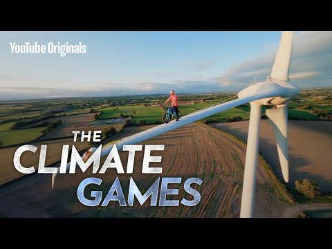 Man With Balls Of Steel Cycles Across The Blade Of A Wind Turbine To Make A Point About Renewable Energy